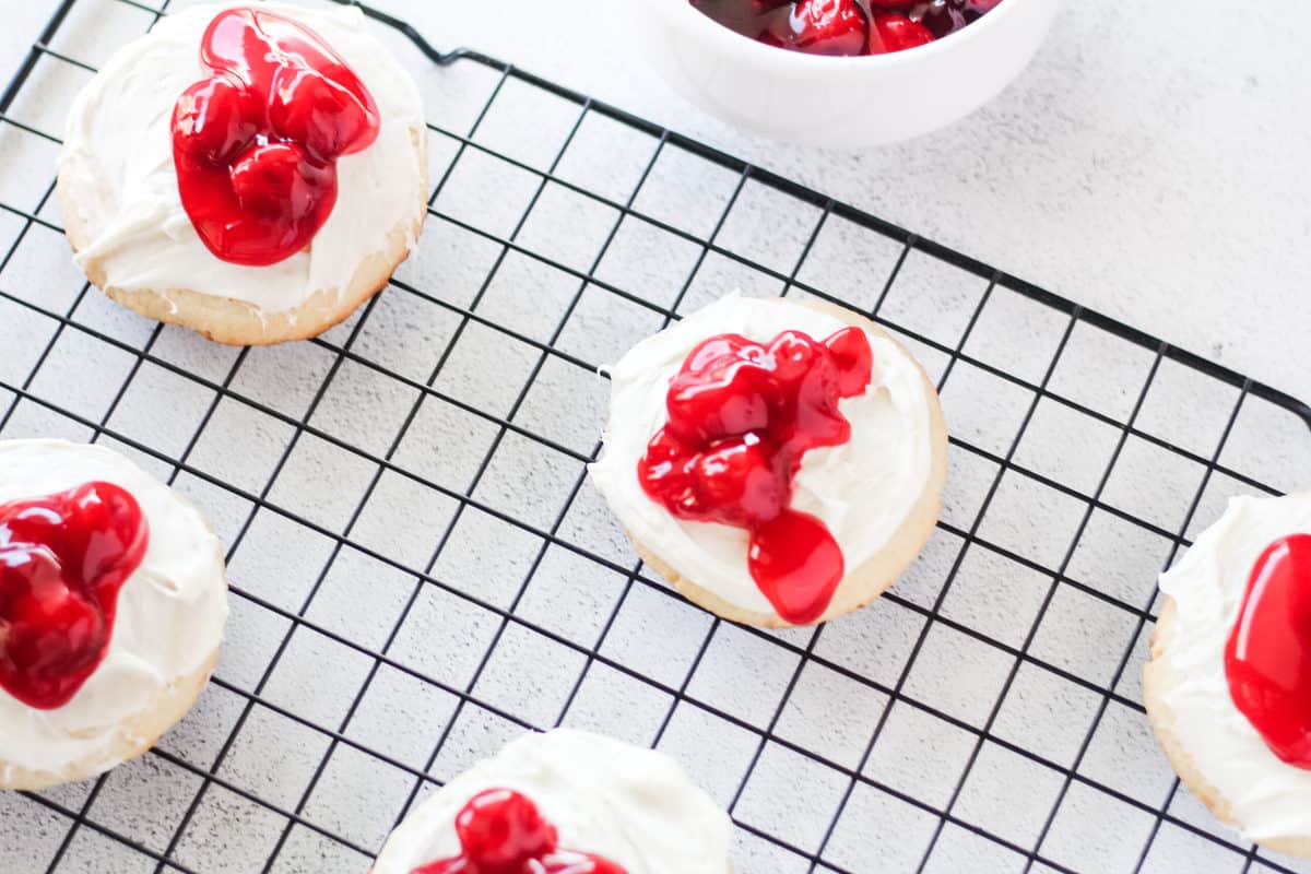 Cherry cheesecake cookies on wire rack.