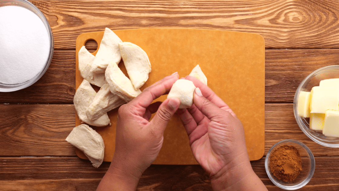 Separate biscuits into two layers and roll into balls.