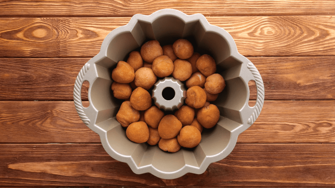 Place coated dough balls into bundt pan.