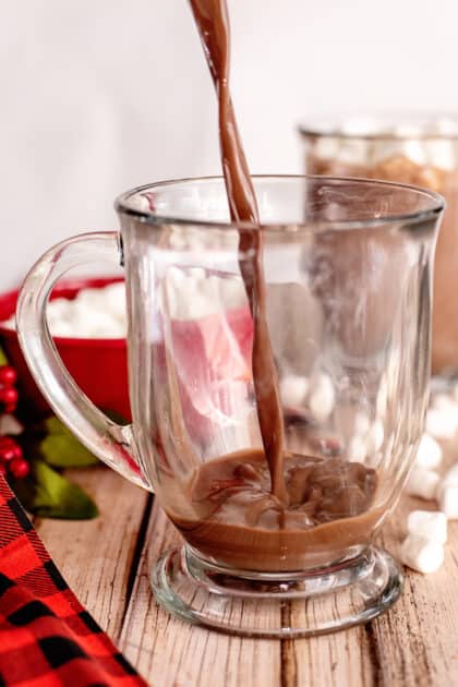 Pour stovetop hot chocolate into cups.