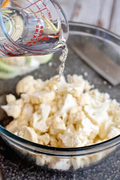 Place cauliflower and water in microwave-safe bowl.