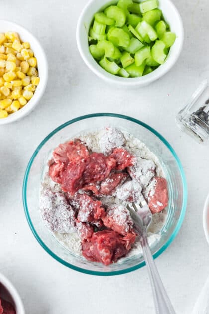 Toss beef in flour, salt, and pepper.