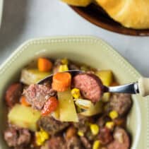 Spoonful of sausage and beef stew.