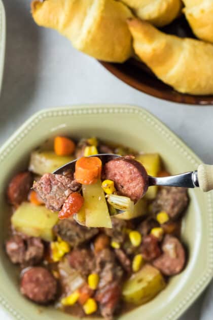 Spoonful of sausage and beef stew.