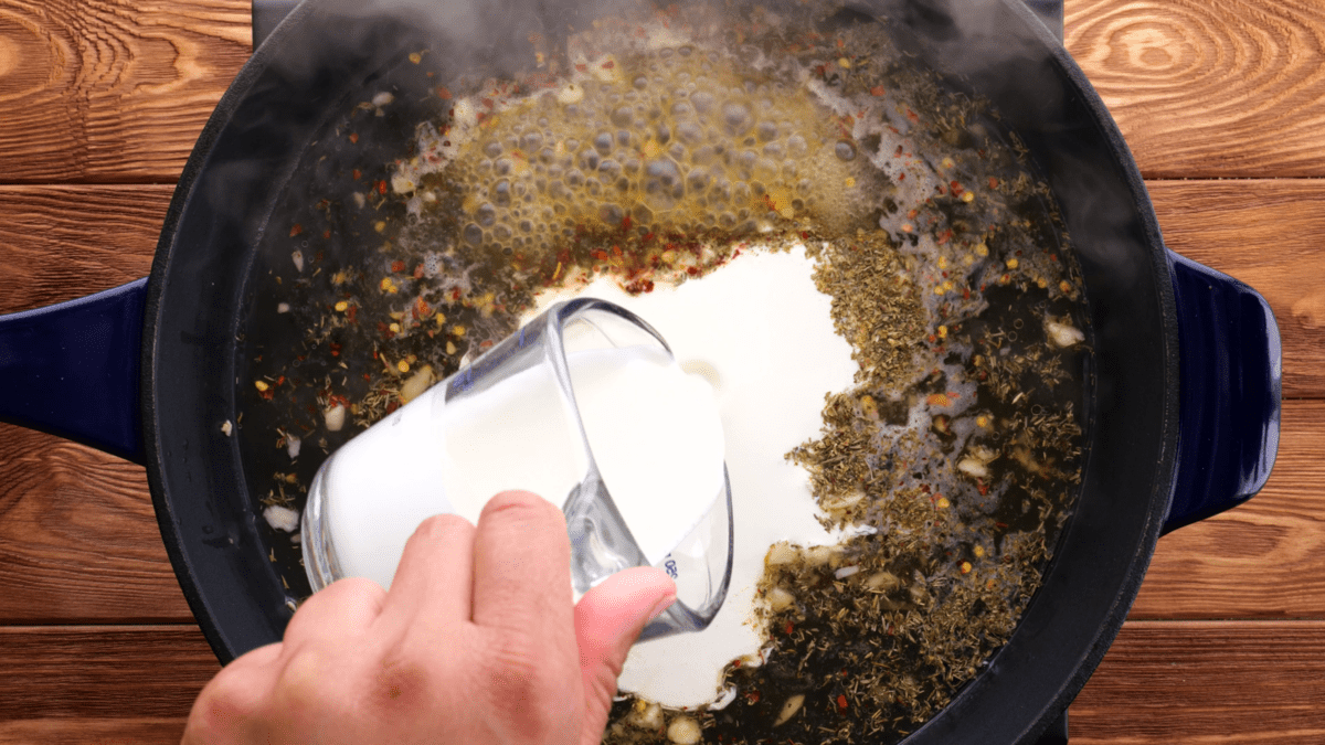 Add heavy cream to the skillet.