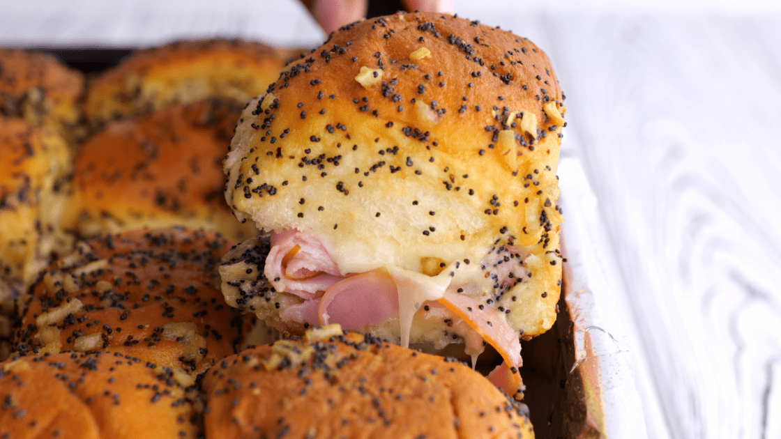 Removing ham and Swiss slider from pan.