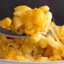 Close-up spoonful of baked mac and cheese.