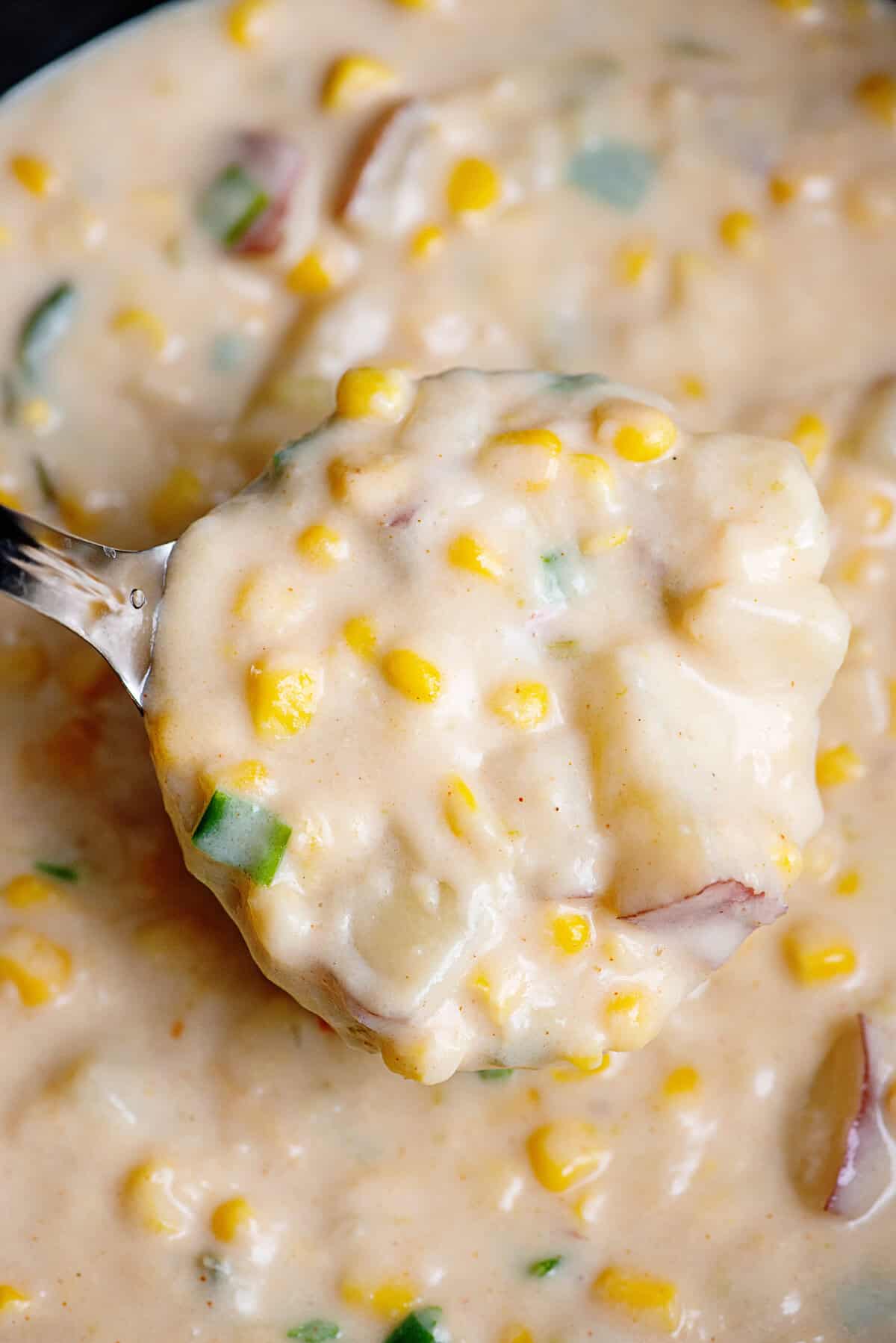 Close-up of a spoonful of potato corn chowder.