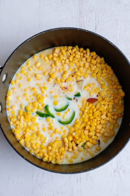 Ingredients for potato corn chowder in a pan.