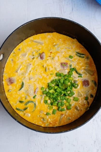 Corn chowder simmering in a pot.