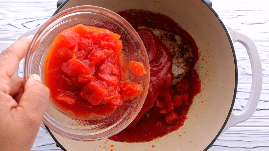 Add remaining canned tomatoes to pan.