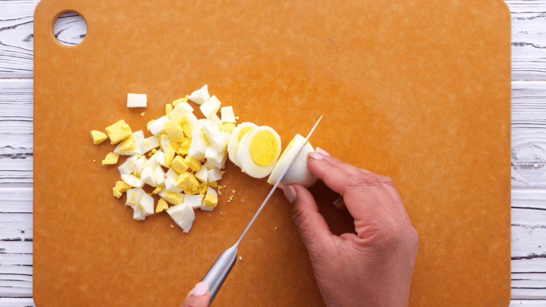 Chop up boiled eggs.