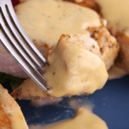 Close-up of pan-seared pork chop with velvet cream sauce.