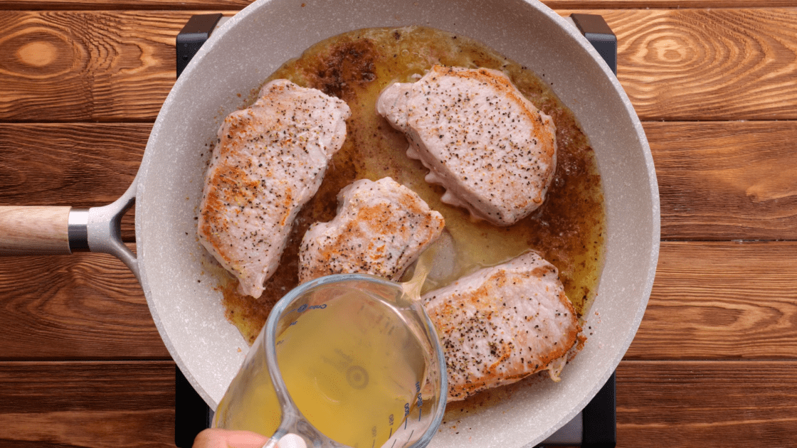 Add broth to skillet.