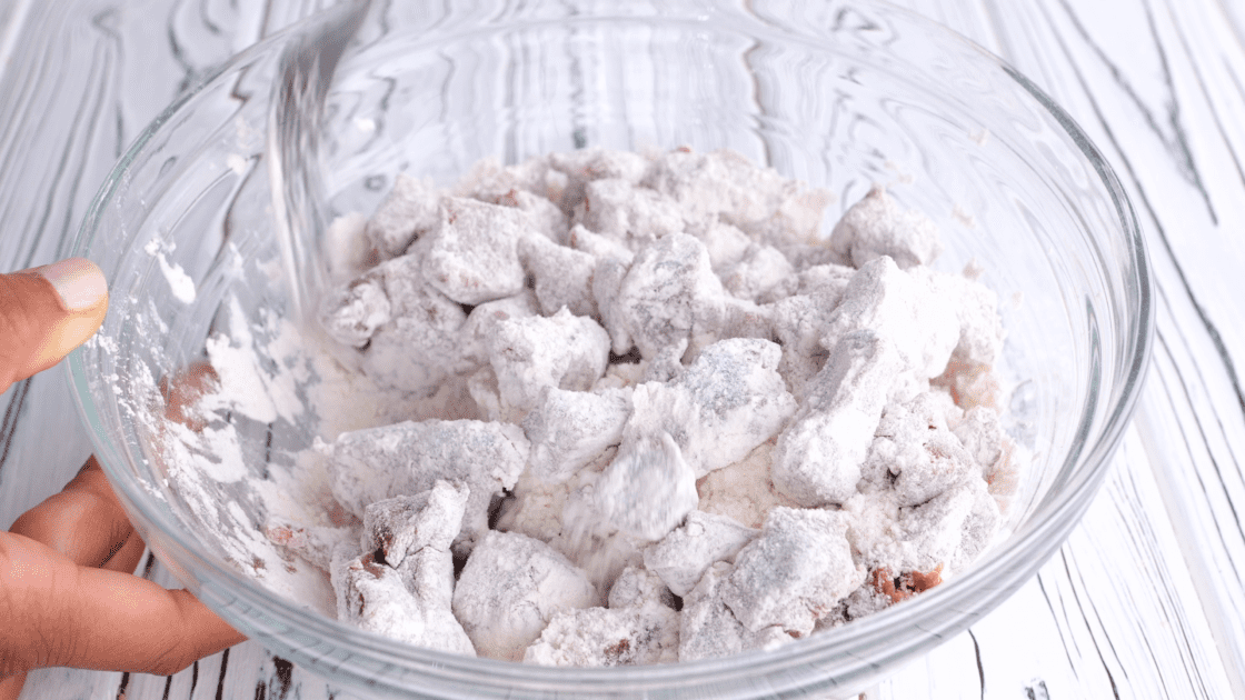 Stir together stew meat and flour in bowl.