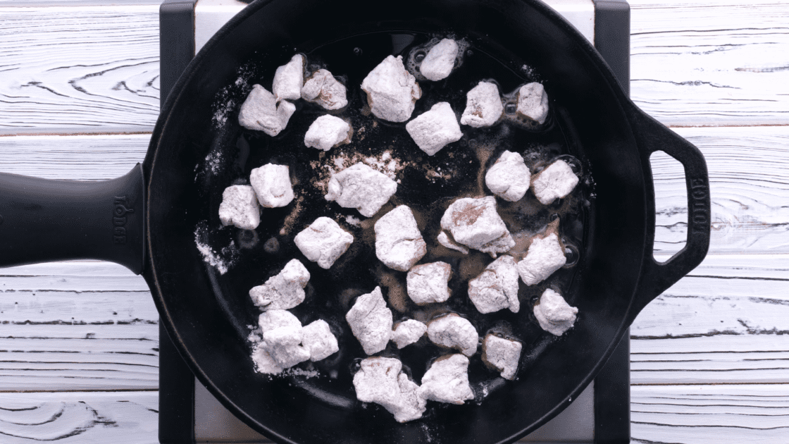 Cook floured meat in skillet.
