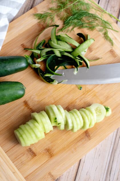 Peel and slice cucumbers.