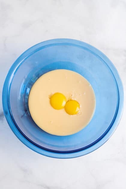 Combine yolks and condensed milk in mixing bowl.