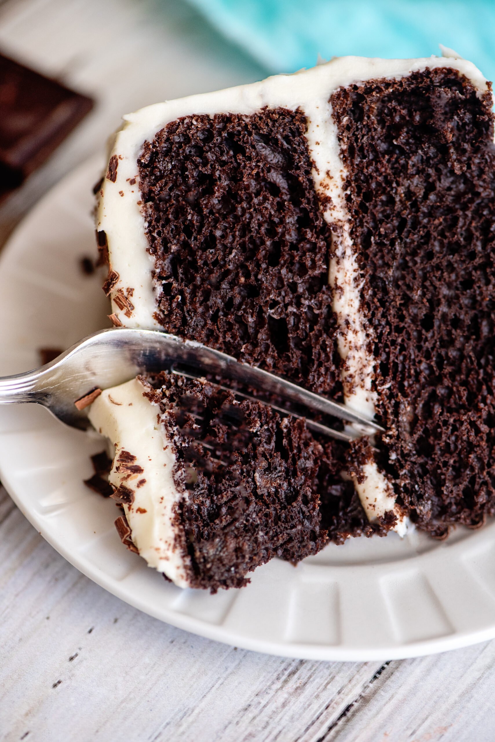 A fork breaking off a piece of chocolate velvet cake.