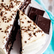 Slice of chocolate velvet cake with cream cheese icing.