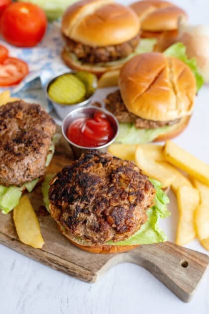 Assembling meatloaf burgers on buns.