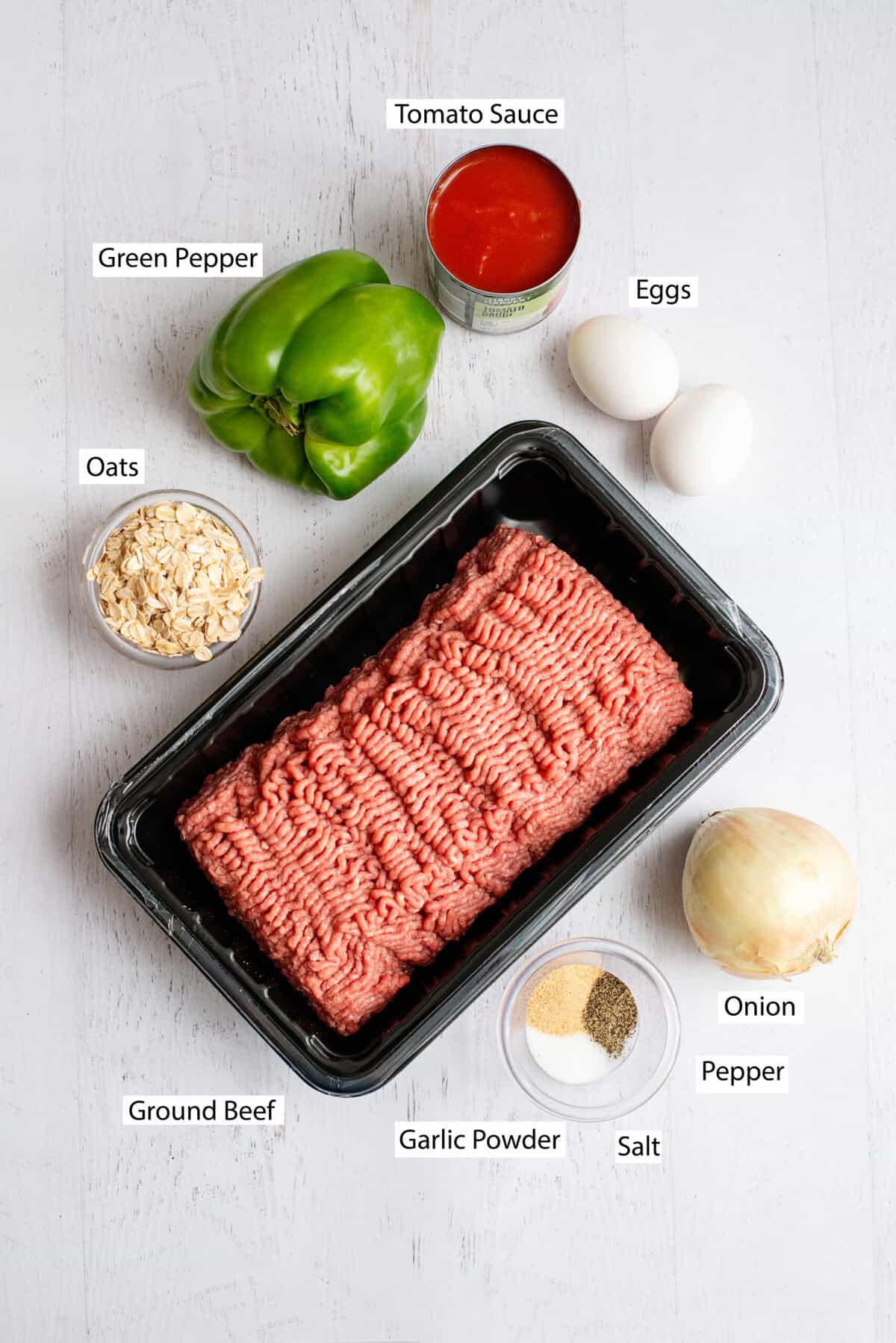 Ingredients for meatloaf burgers include ground beef, tomato sauce, quick oats, eggs, chopped onion, chopped bell pepper, garlic powder, salt, and black pepper.
