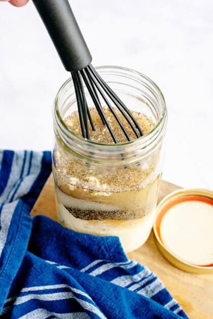 Whisking a mason jar of ingredients.