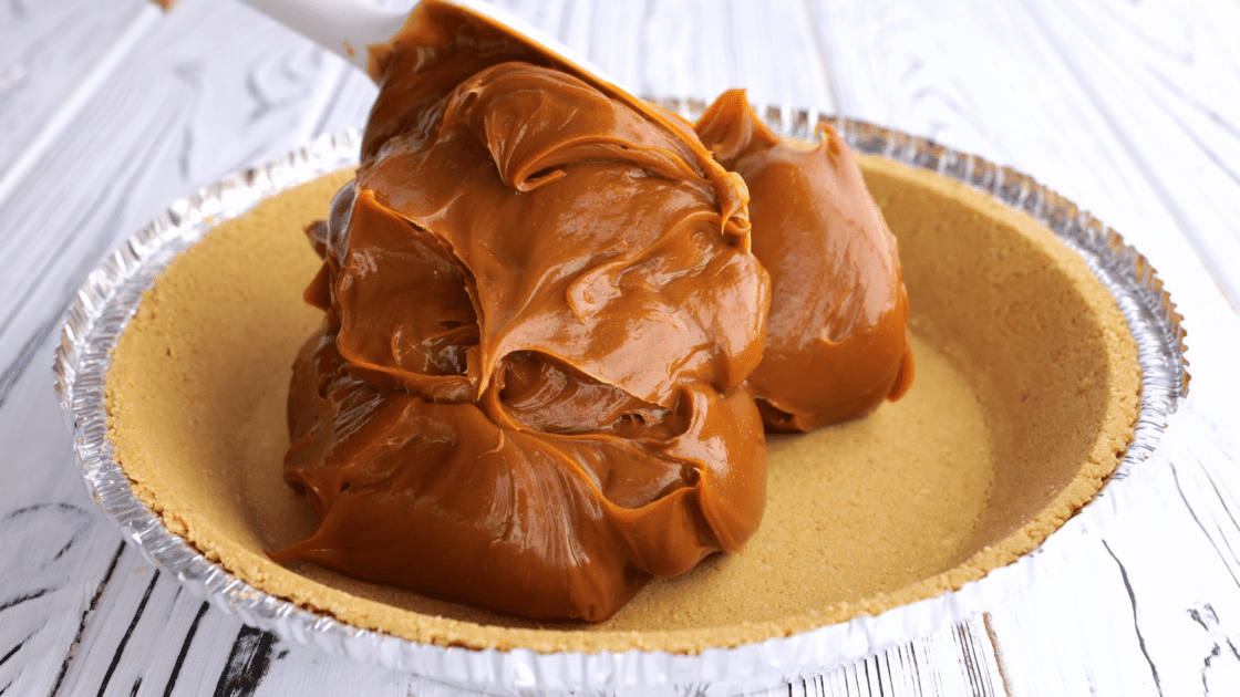 Dollop caramel into pie crust.