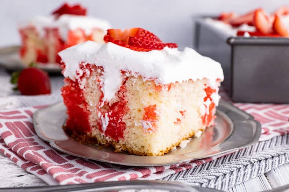 Slice of strawberry poke cake (summer dessert recipe ideas).