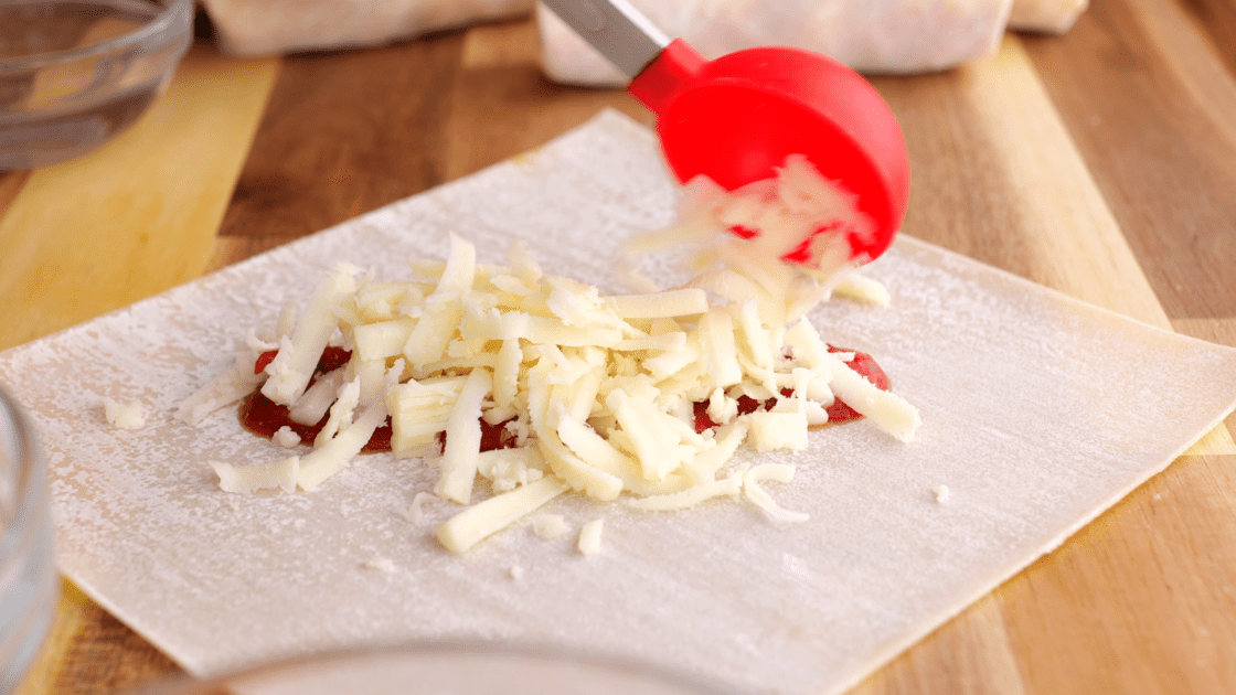 Add mozzarella cheese on top of sauce.