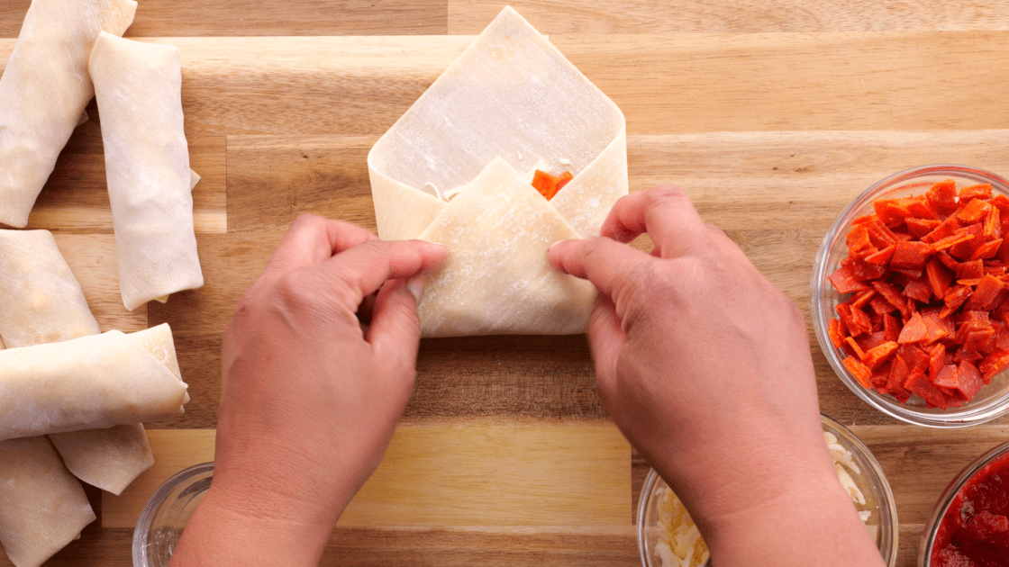 Take the side of the egg roll and fold it into the center.