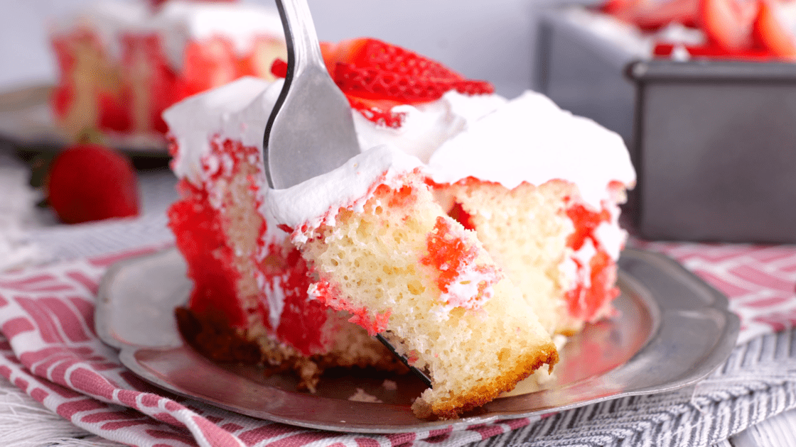 Forkful of strawberry poke cake.