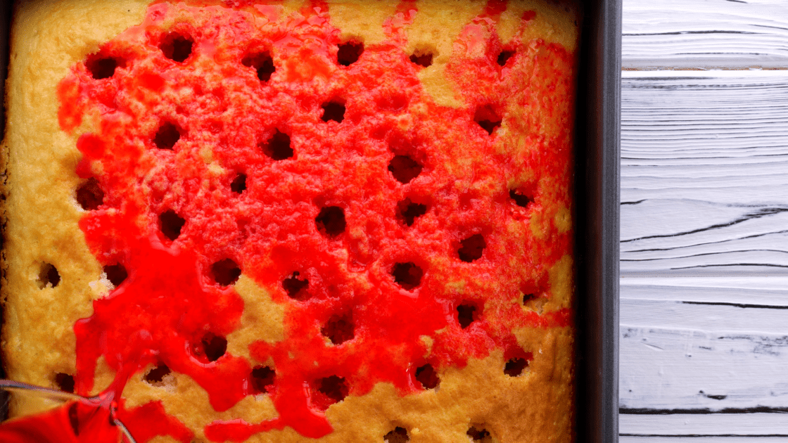 Pour jello over the holes in the cake.