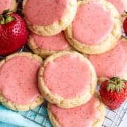 Stack of strawberry frosted cookies.