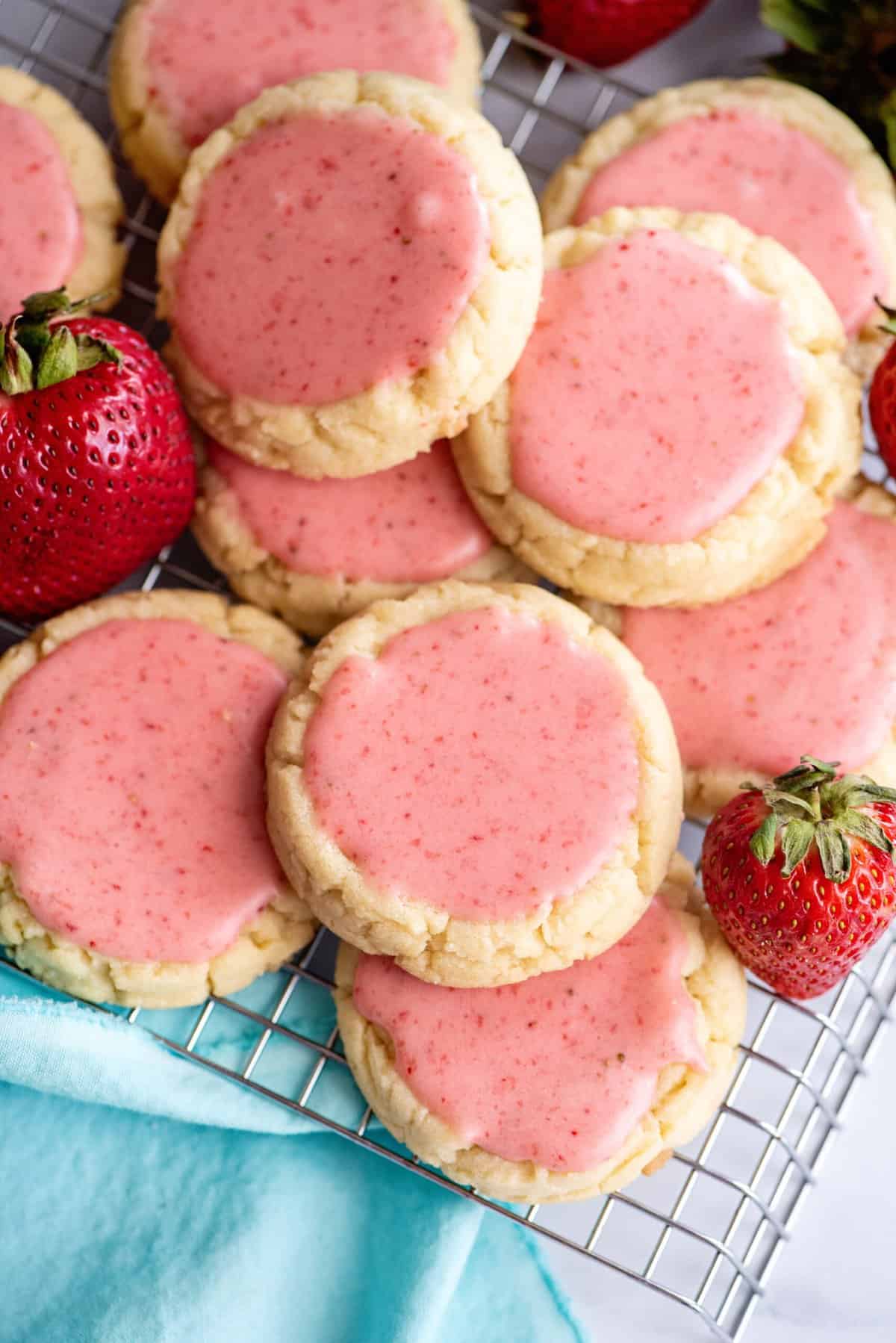 Stack of strawberry frosted cookies.