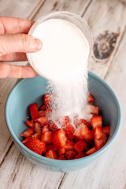 Wash and cut strawberries and toss with sugar.