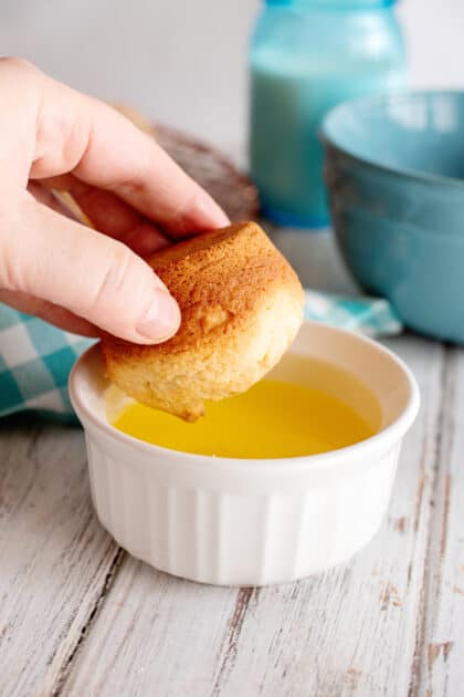 Dip each French breakfast puff in melted butter.