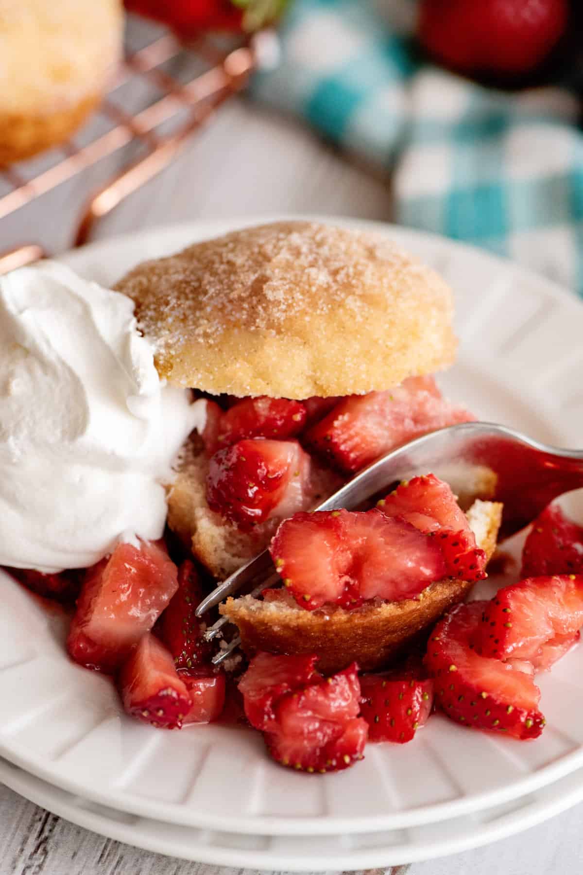 Breaking off a piece of french breakfast puff with fresh strawberries.