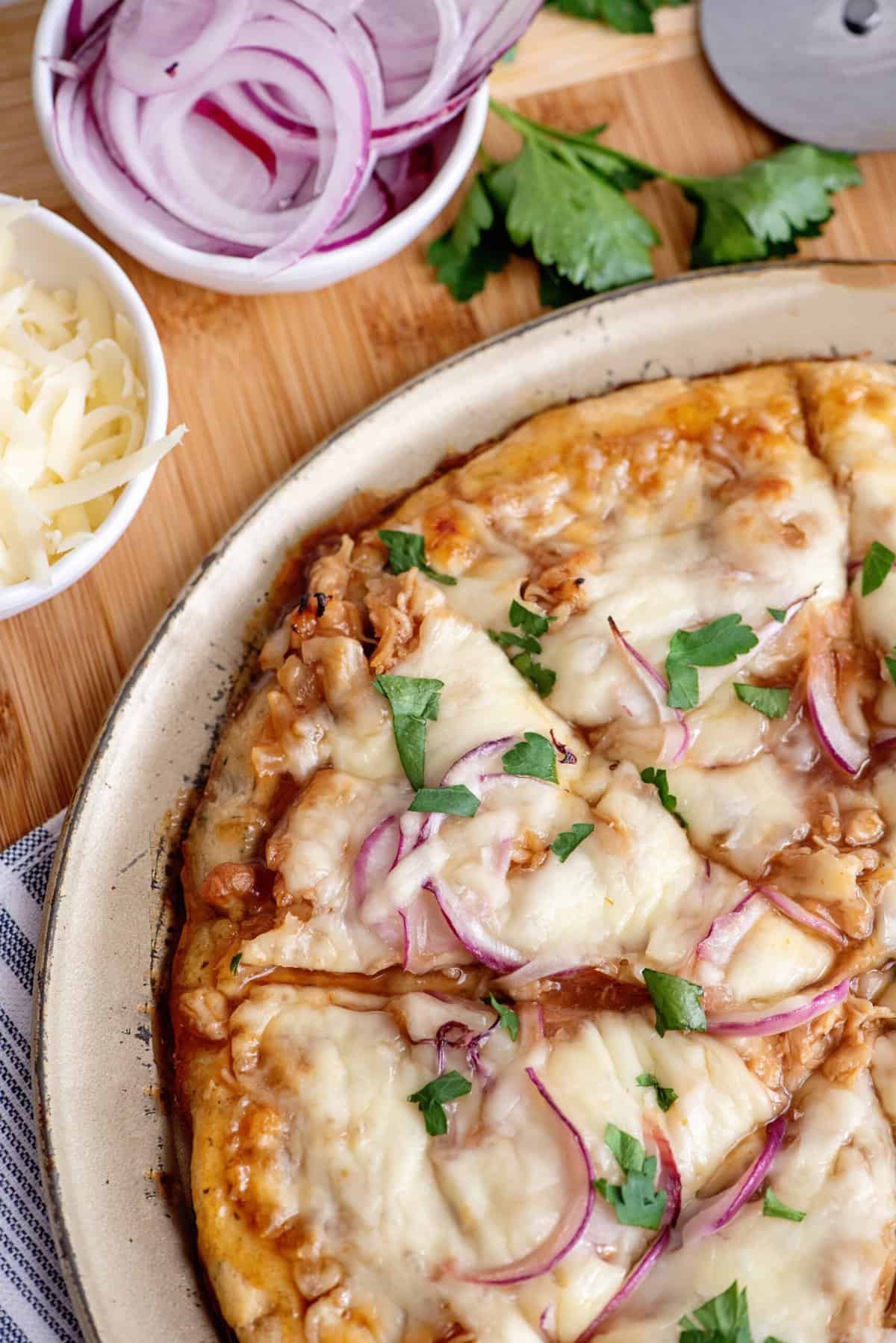 Slicing barbecue chicken pizza.