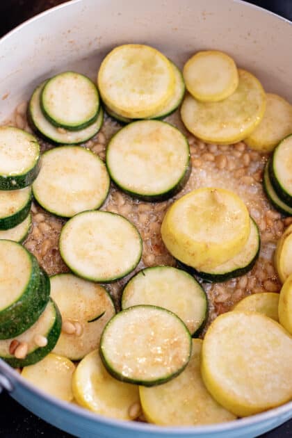 Add garlic and squash to skillet.