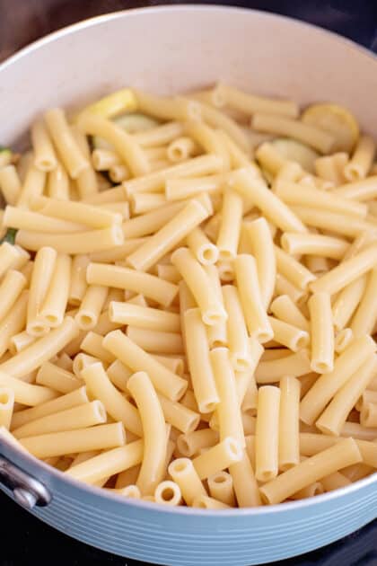 Add cooked pasta to skillet.
