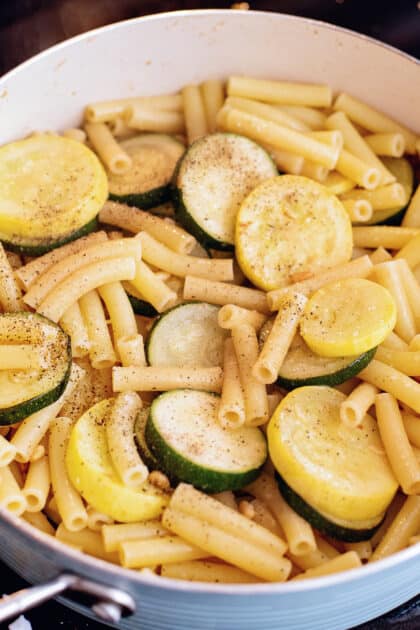 Mix together pasta and squash in skillet.