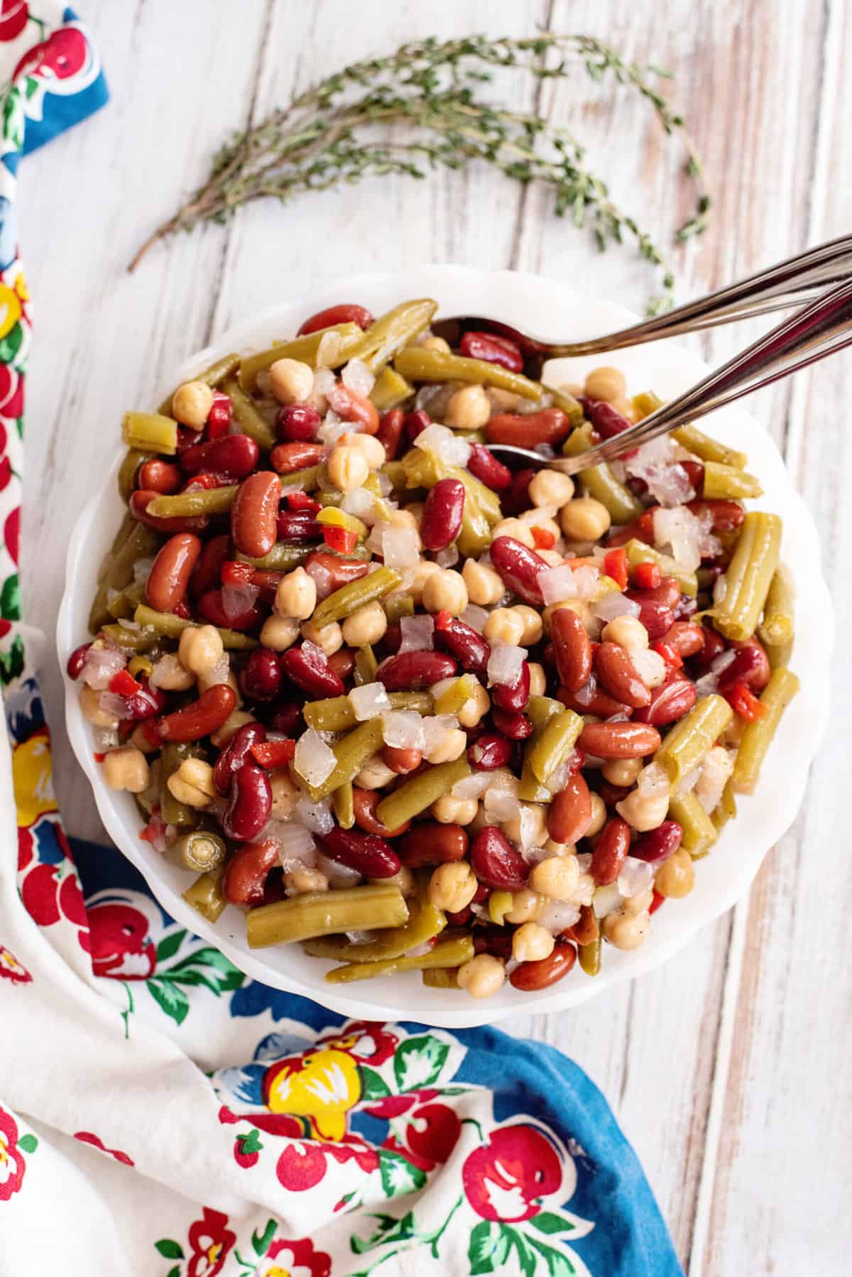 Serving bowl of 3 bean salad with dressing.