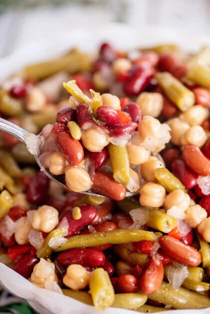 Spoonful of 3 bean salad with dressing.