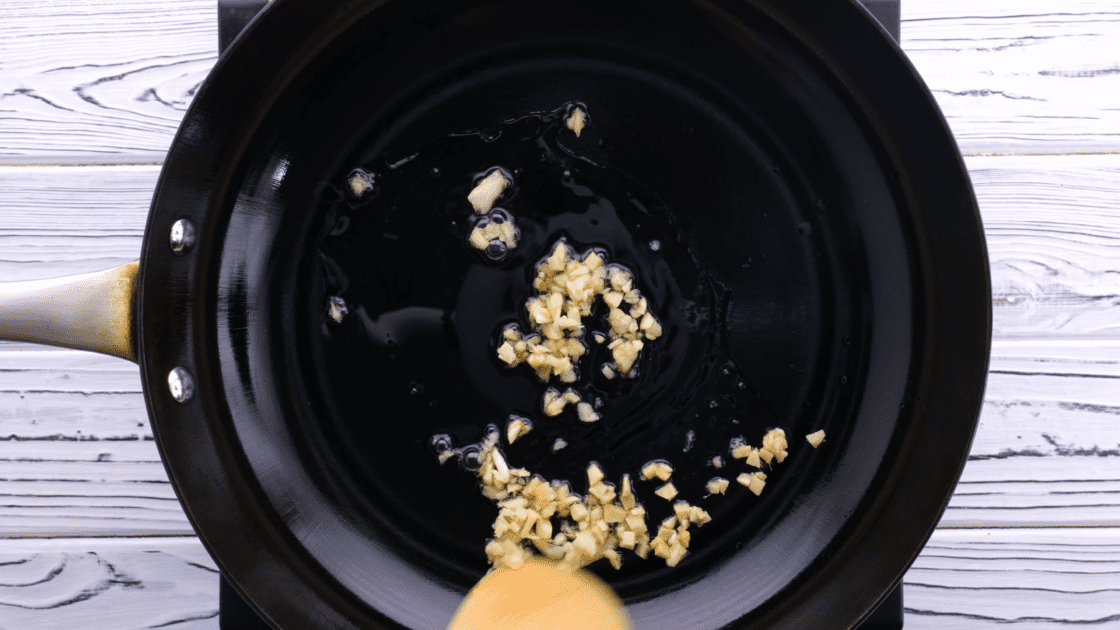 Cook minced garlic and ginger in skillet.