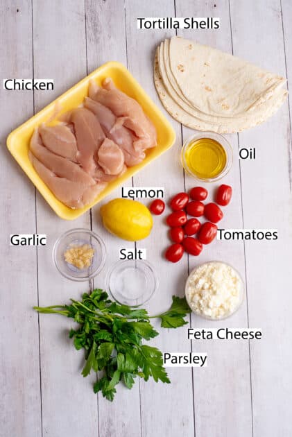 Labeled ingredients for Greek chicken tacos.