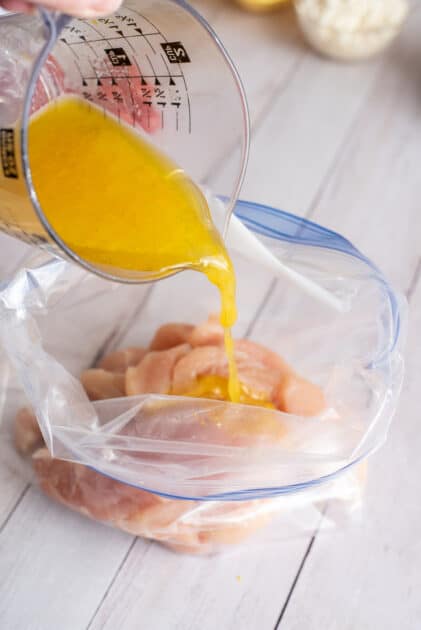 Pour homemade marinade over chicken in the zipper seal bag.