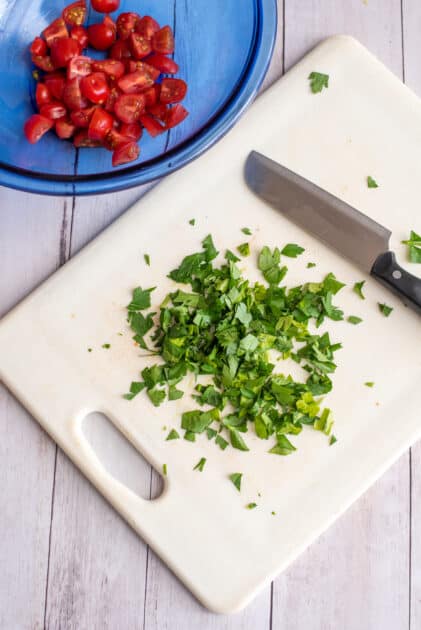 Chop up fresh parsley.