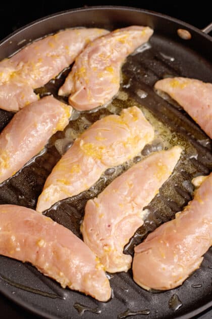 Add marinated chicken to skillet.