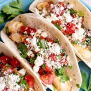 Plate of Greek chicken tacos.